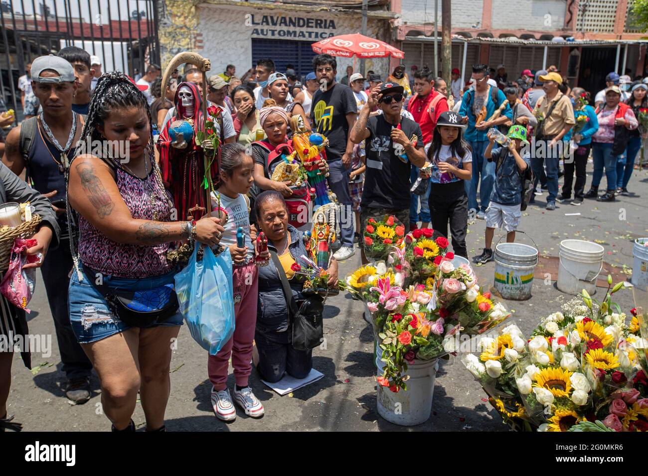 A faithful holds a statue of Santa Muerte, while arriving at the Altar of Santa Muerte in the town of Tepito, as part of the celebrations that held on the first day of each month, hundreds of devotees attend to venerate it, give thanks for the favors and the fulfilled promises that this deity has granted them. La Santa Muerte or Santisima Muerte is a popular Mexican figure who personifies death and is an object of worship, the devotees of her are usually perceived as people associated with crime, gang activity, prostitution, drug trafficking. On June 1, 2021 in Mexico City, Mexico. (Photo by E Stock Photo