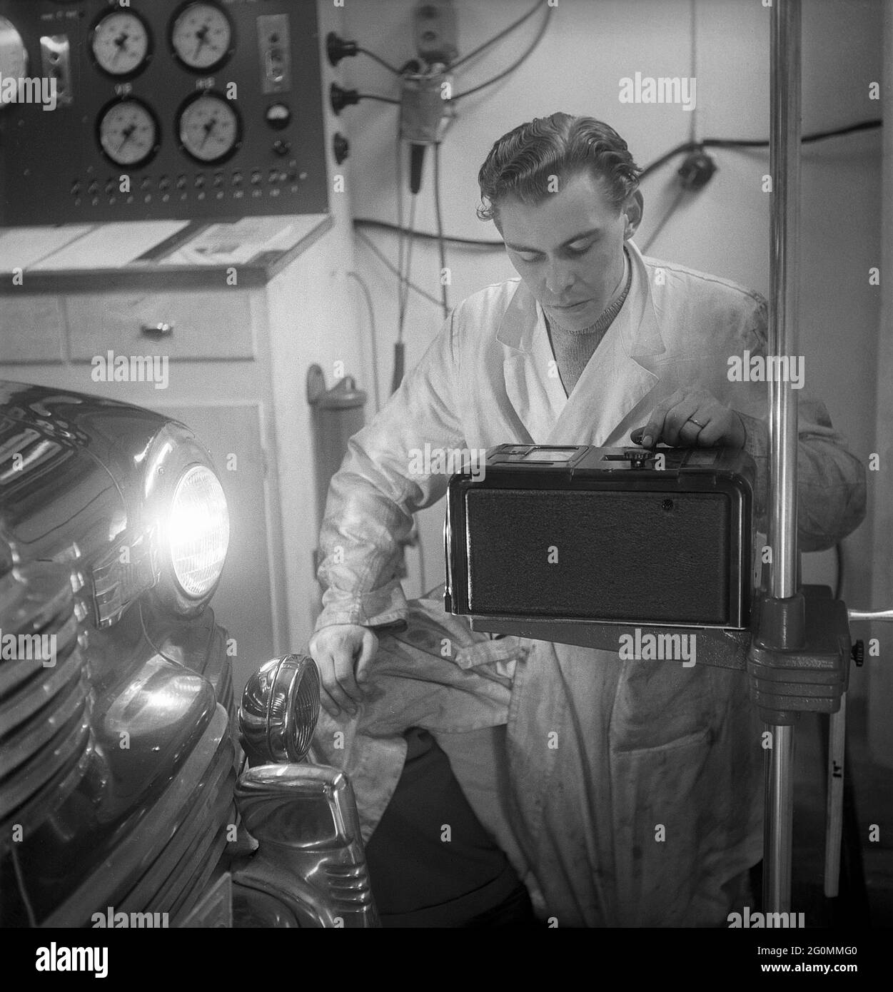 Cars in the 1950s. At this time the yearly mandatory checkup and control of cars was not in affect. Picture taken at the garage of the Swedish Royal Automobile club where a car is controlled that everything is in working order. Sweden 1951. ref BB69-3 Stock Photo