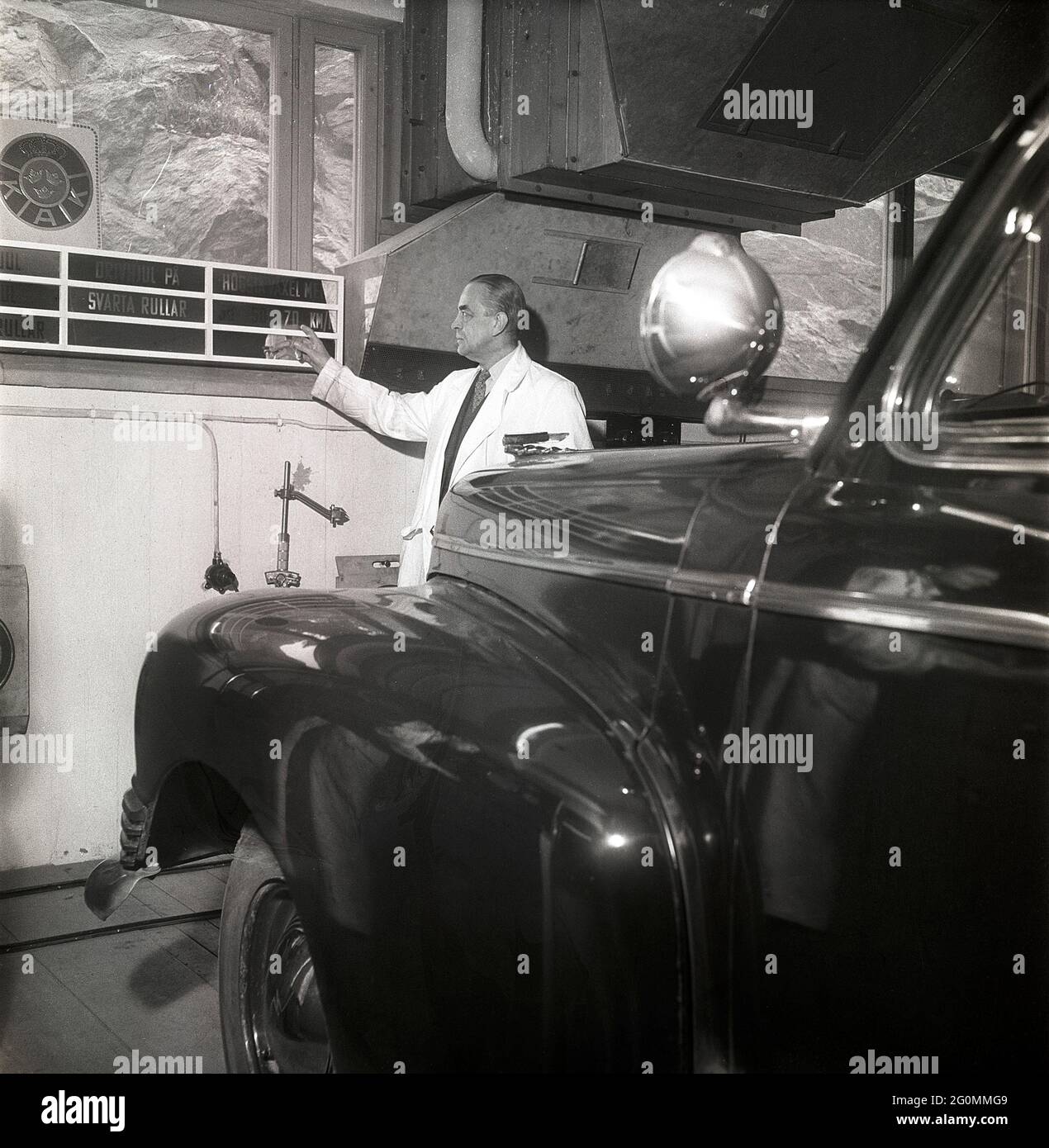 Cars in the 1950s. At this time the yearly mandatory checkup and control of cars was not in affect. Picture taken at the garage of the Swedish Royal Automobile club where a car is controlled that everything is in working order. Sweden 1951. ref BB69-4 Stock Photo