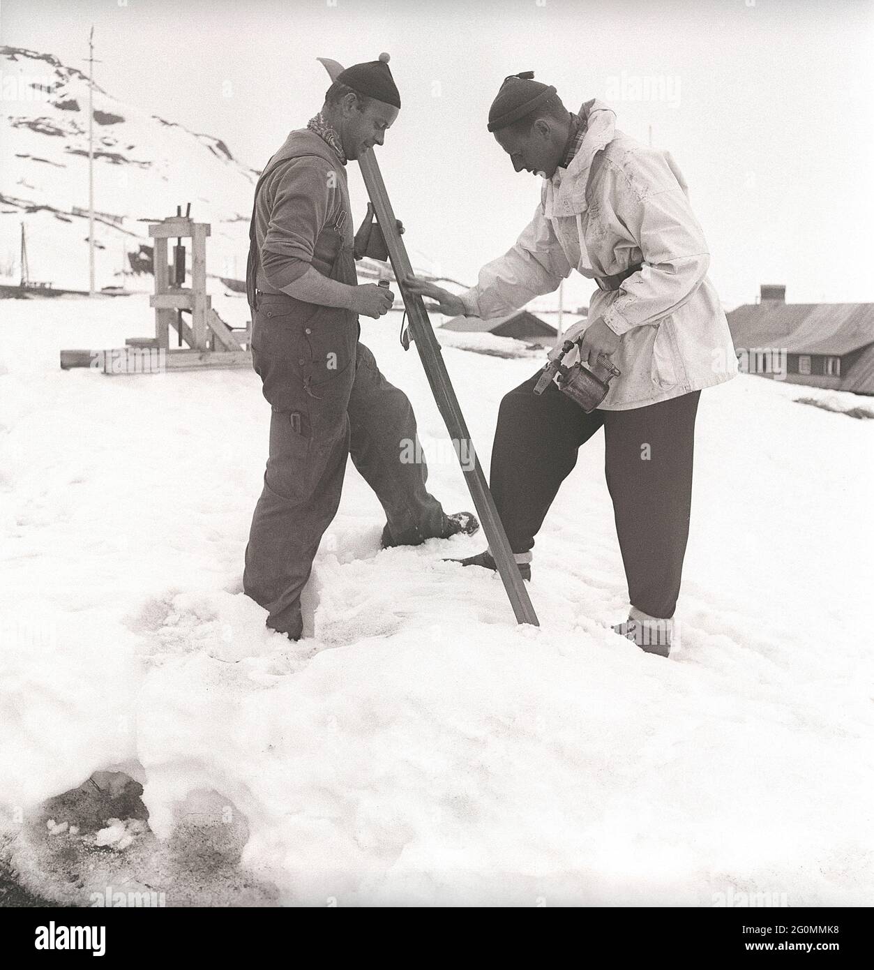 Winter in the 1940s. Two men are going skiing and prepares the skis