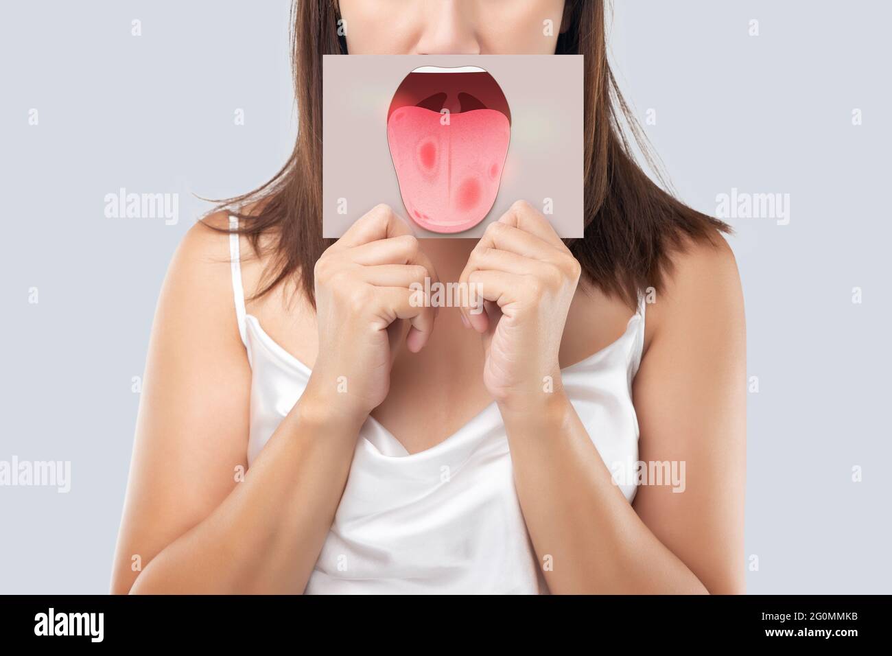 The woman show the picture of tongue problems, Illustration benign migratory glossitis on a brown paper, Behcet's Disease Stock Photo