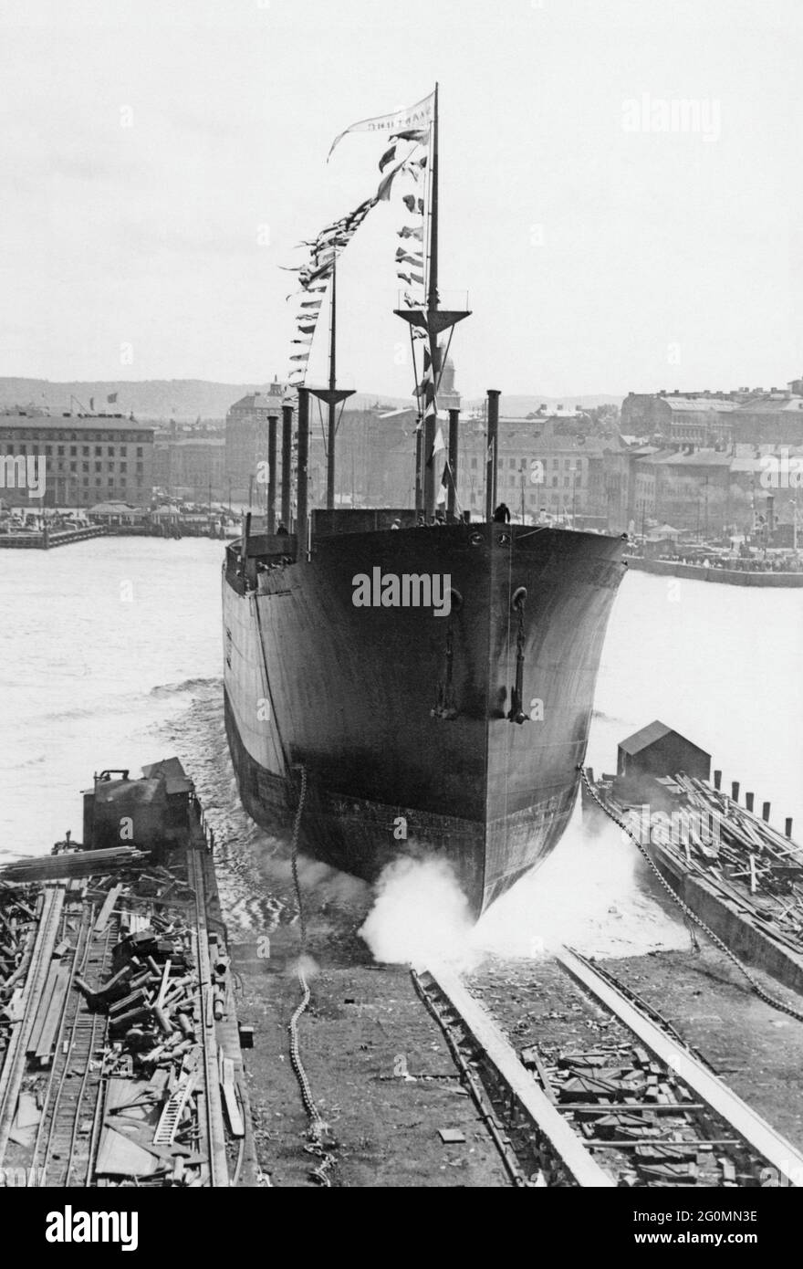 Shipyard in the 1920s. In the harbor of Gothenburg and the shipping wharf of Götaverken a ship is being launched. A majestic photograph of the ship sliding into the water. It is the Swedish East India Companys new ship Shantung that is being launched on June 7 1929. The company have a long history of trading with East India and used their own ships. Stock Photo