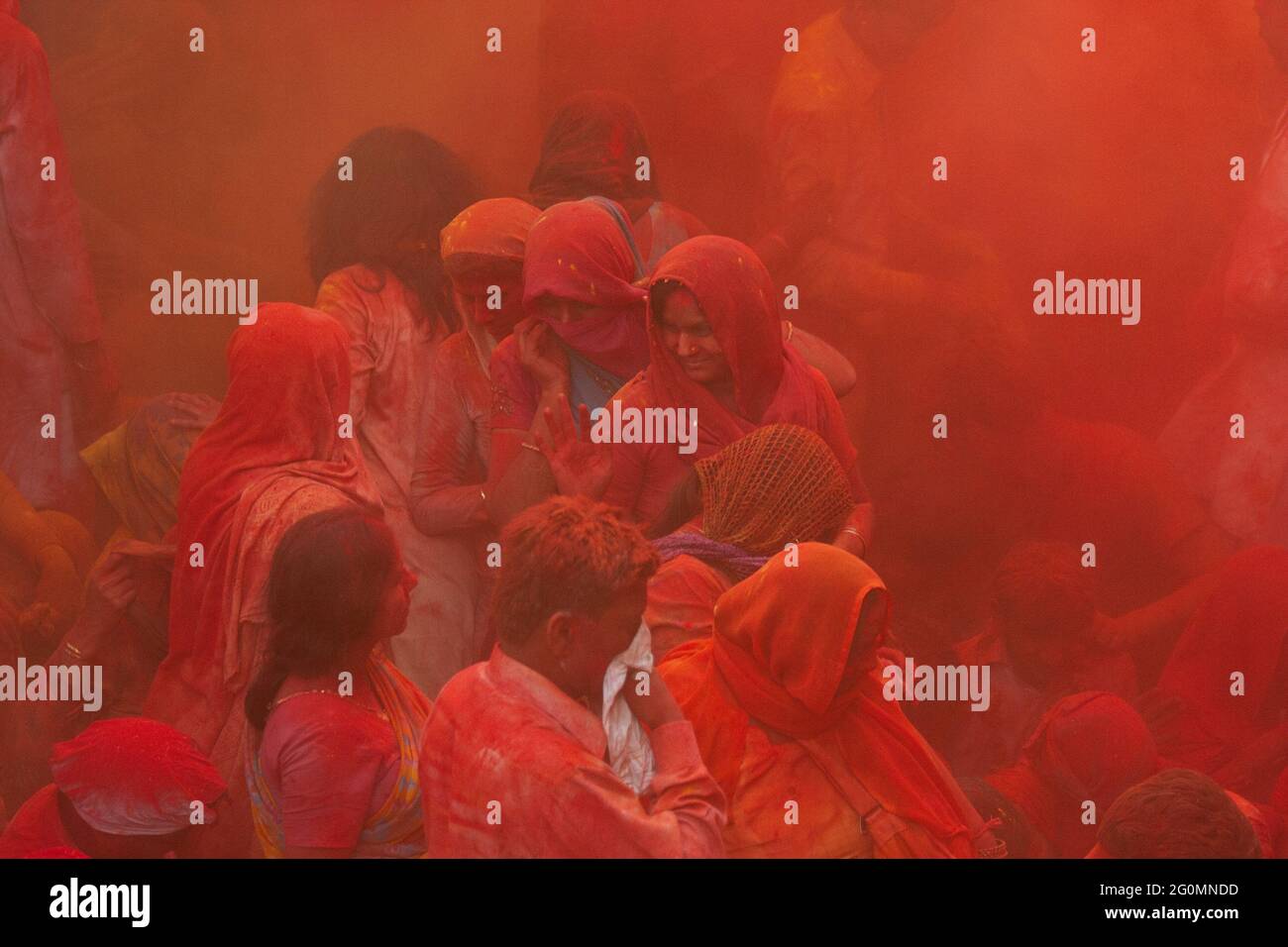 Indian people gathered in a temple and playing holi with colourful powder Stock Photo