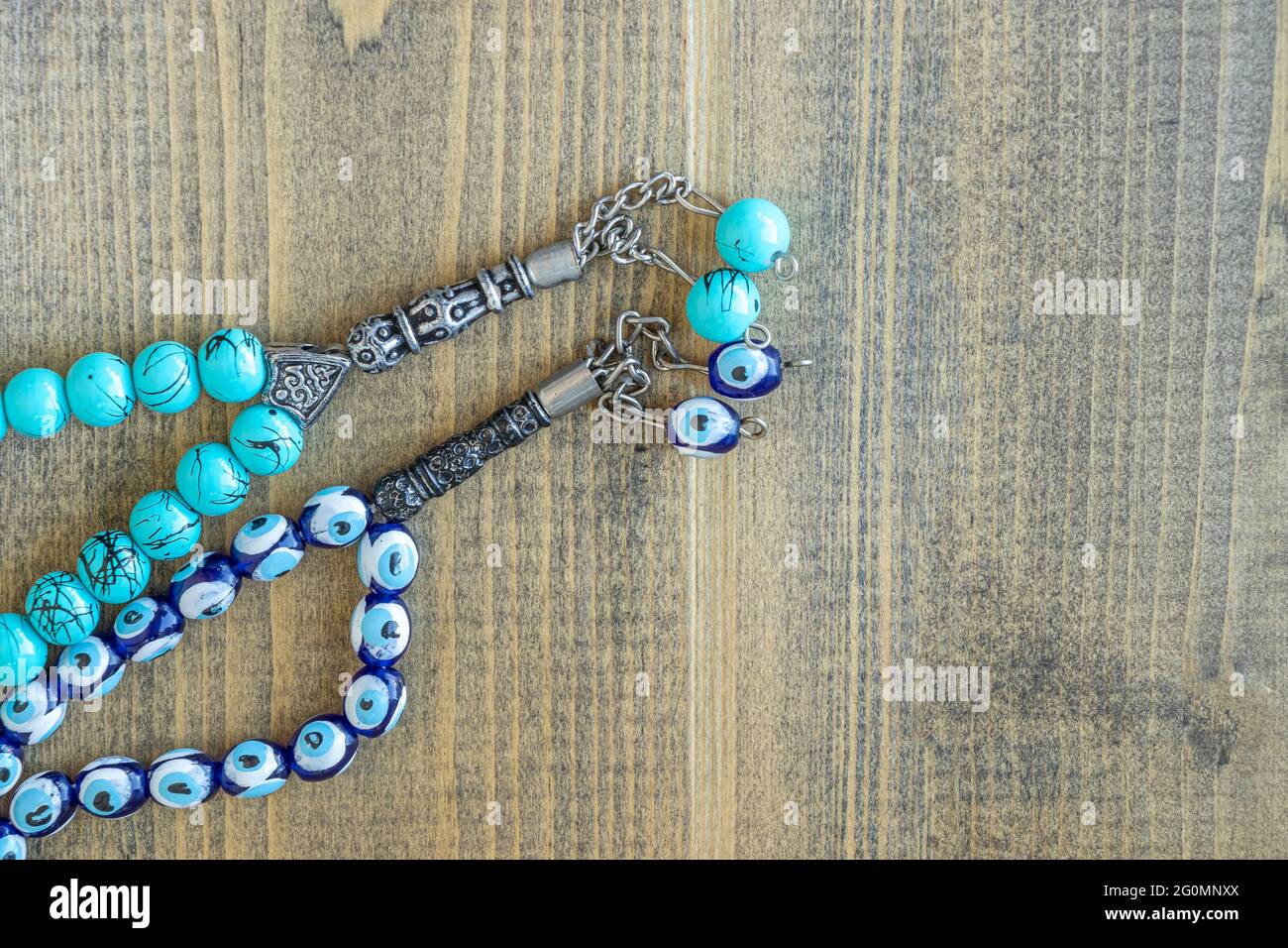 Two blue beads sequenced, short rosary on wooden table. tespih tesbih ...