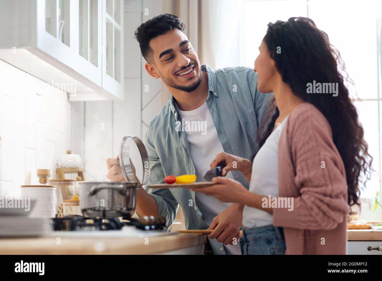 Happy Middle Eastern Spouses Preparing Lunch Together In Kitchen Stock Photo