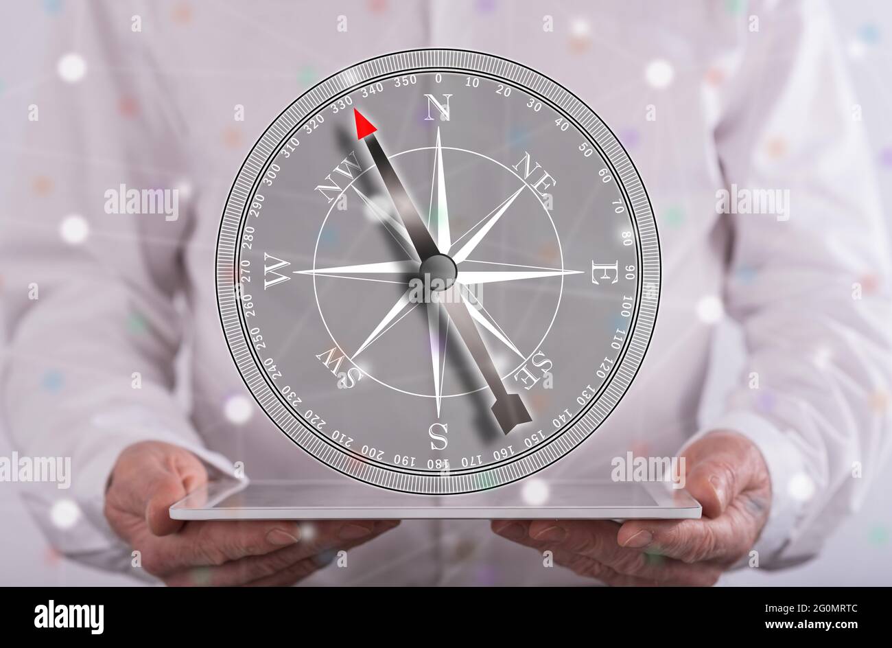 Right direction concept above a tablet held by a man in background Stock Photo