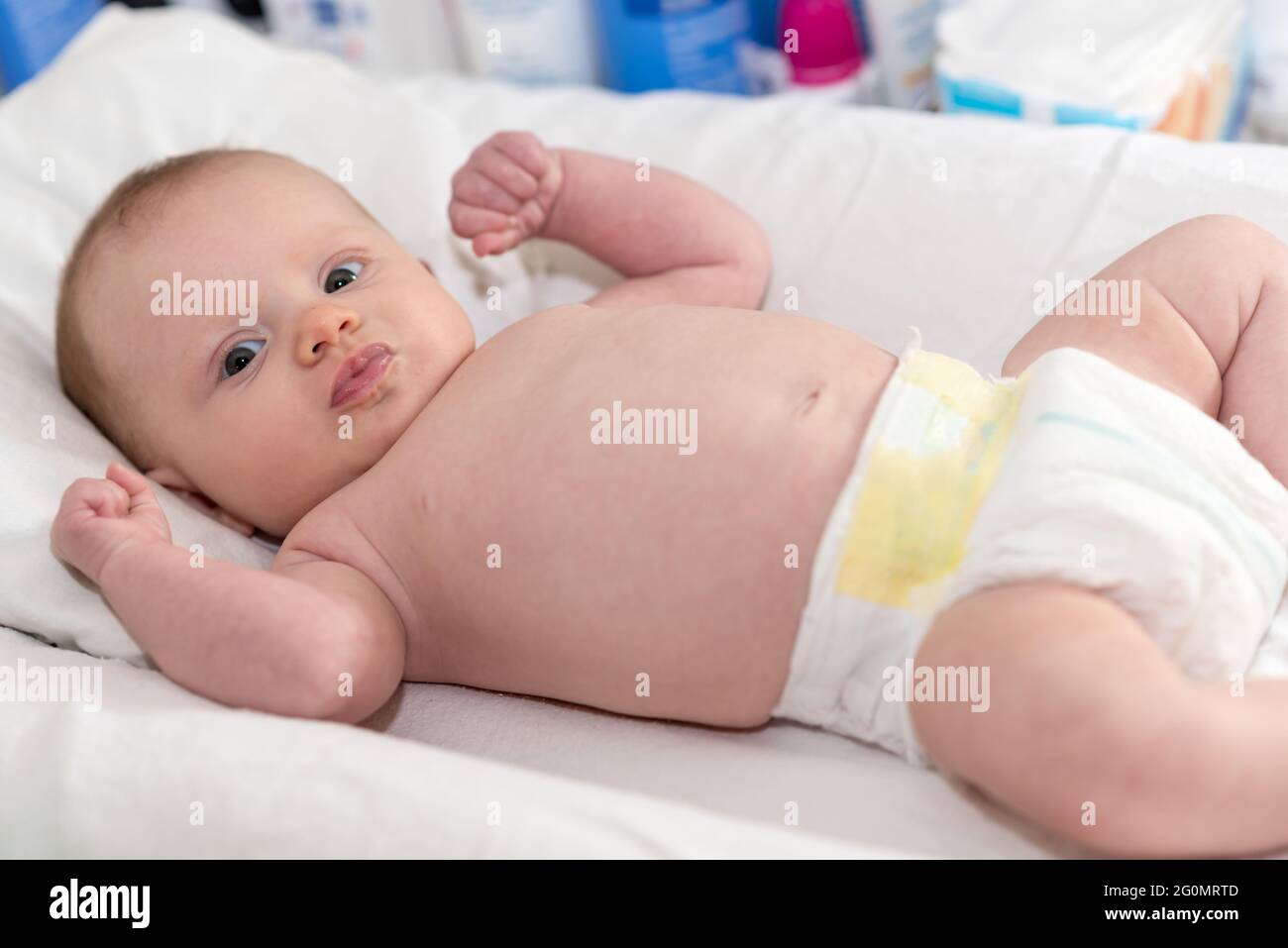 Baby girl on changing diaper table hires stock photography and images