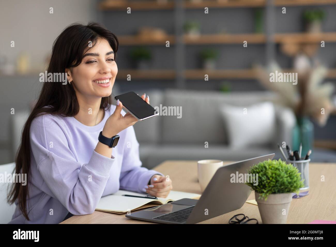 Woman using voice search assistant on cellphone Stock Photo