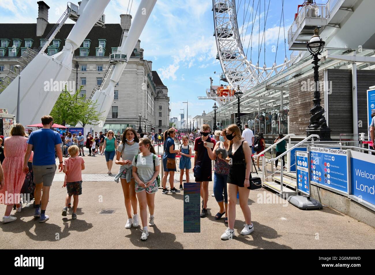 London, UK. The fine weather and a relaxing of lockdown restrictions bring half term crowds flooding back to the capital. The London Eye, Jubilee Gardens, Southbank. Stock Photo