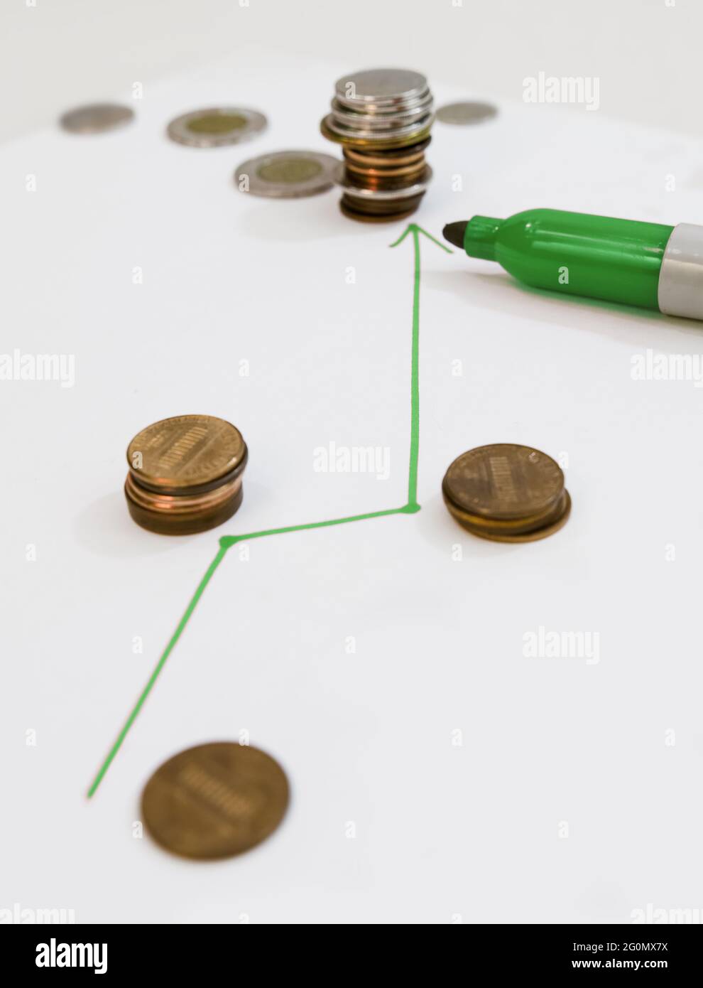 A line drawn with a green marker showing the start of a slight financial growth (currencies, coins). Stock Photo