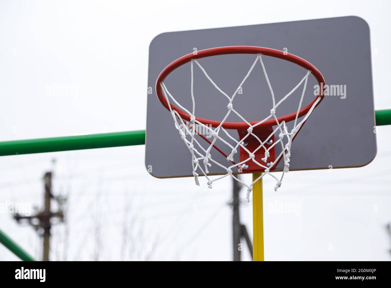 Picture of red basketball ring in cloudy day in the summer Stock Photo