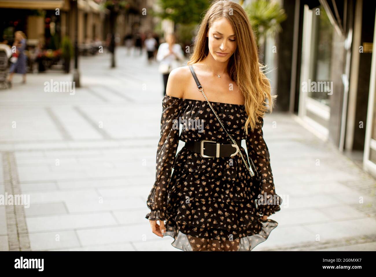 Pretty young long hair brunette woman walking on the city street Stock ...