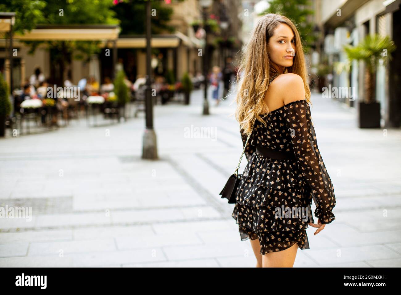 Pretty young long hair brunette woman walking on the city street Stock ...
