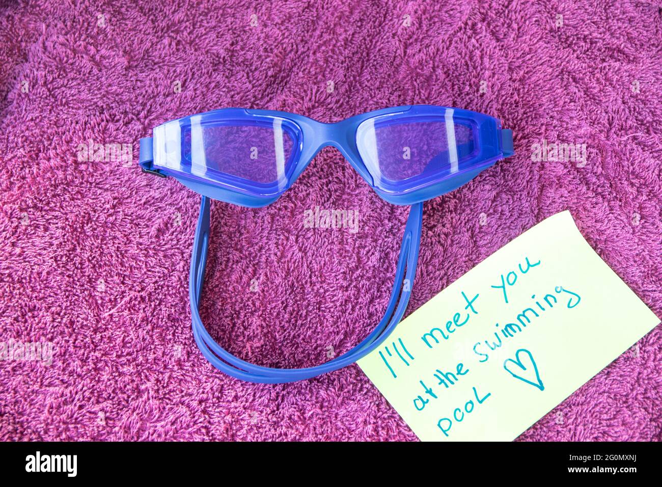 swimming goggles on a bath towel Stock Photo