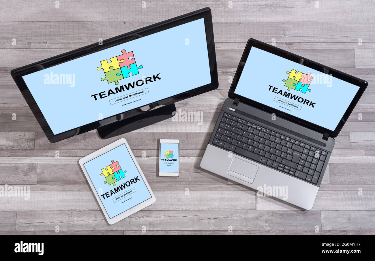 Teamwork concept shown on different information technology devices ...