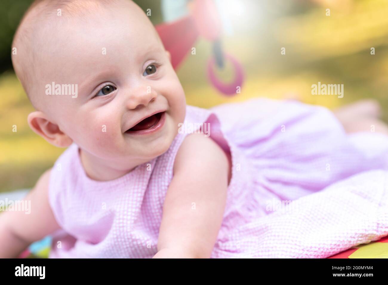 Portrait of cute smiling baby girl outdoors, light effect Stock Photo ...