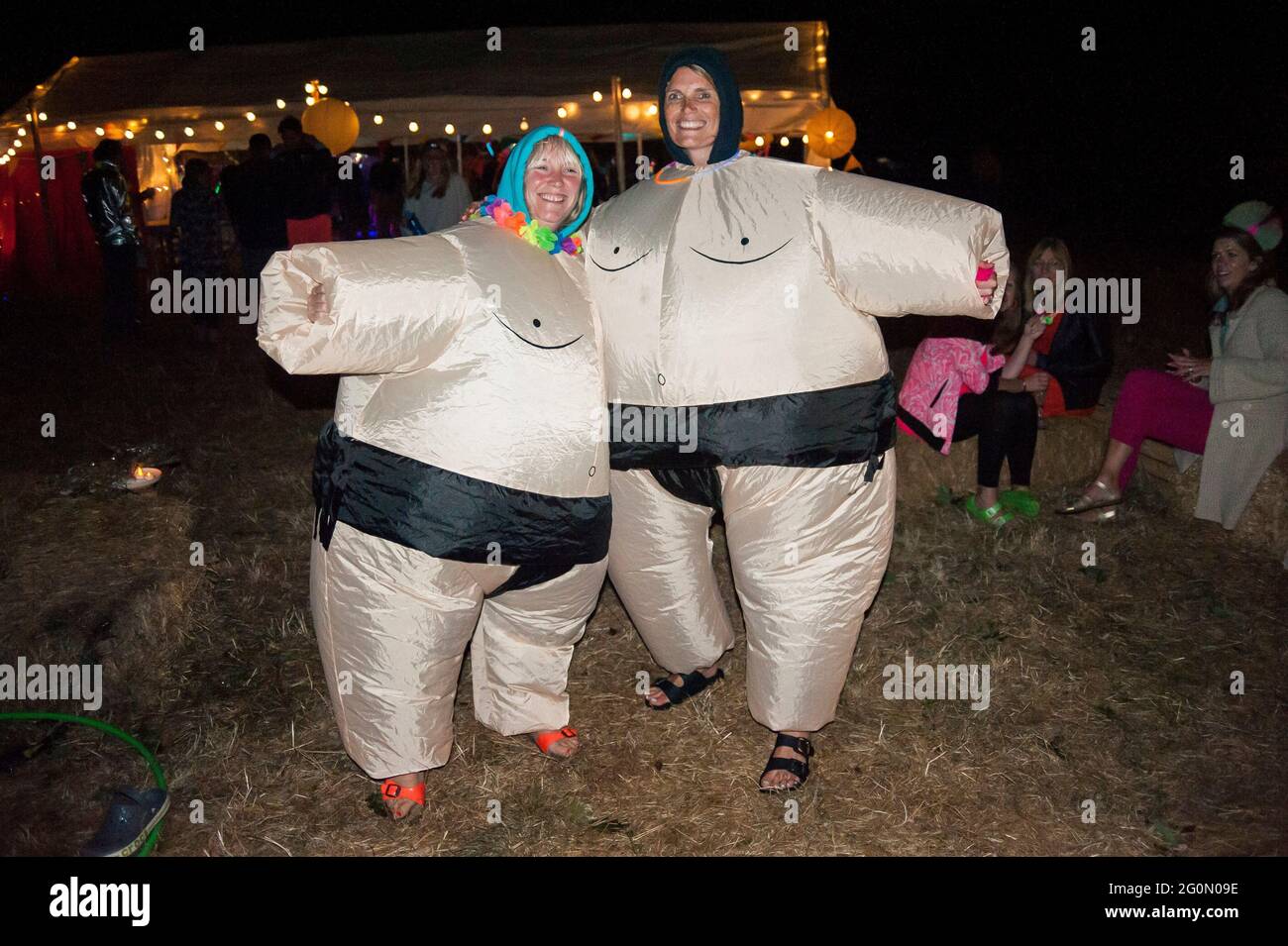 Two women dressed up in inflatable blow up sumo wrestler costumes Stock Photo
