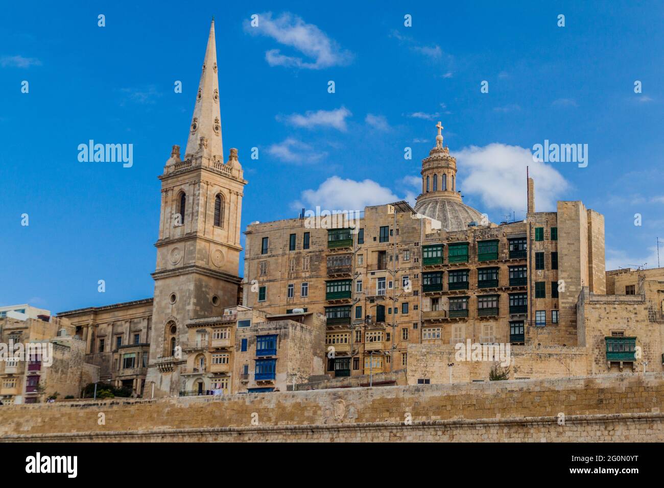 Tower of St Paul's Pro-Cathedral and the cupola of the Basilica of Our Lady of Mount Carmel in Valletta, Malta Stock Photo