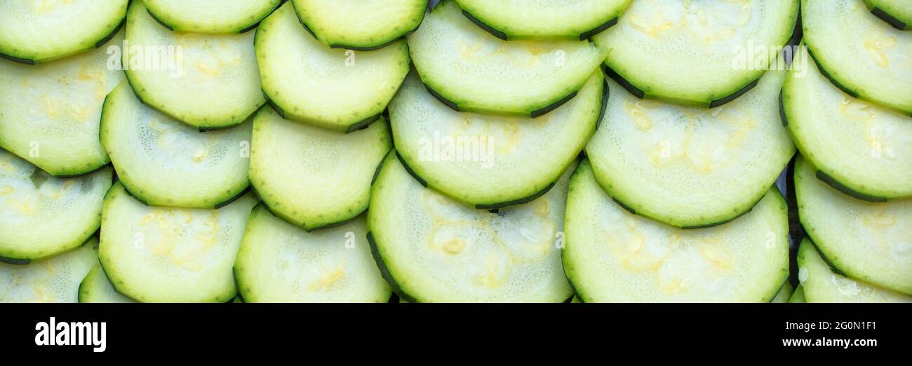 Fresh raw sliced zucchini courgettes panoramic background Stock Photo
