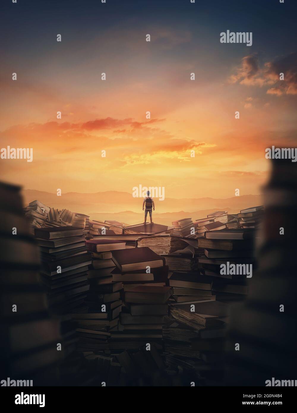 Surrealistic scene with a tiny man climbing on the top of a huge books landfill. Different thrown book piles and a person silhouette against sunset. E Stock Photo