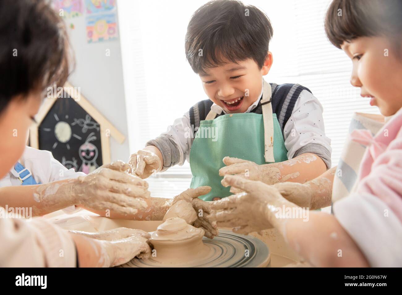 Happy children handmade pottery class Stock Photo Alamy