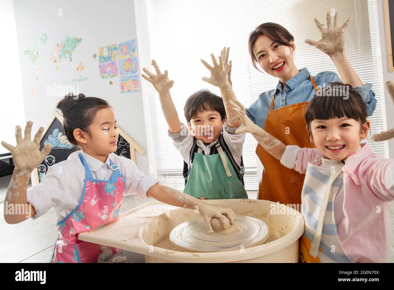 Happy children handmade pottery class Stock Photo - Alamy