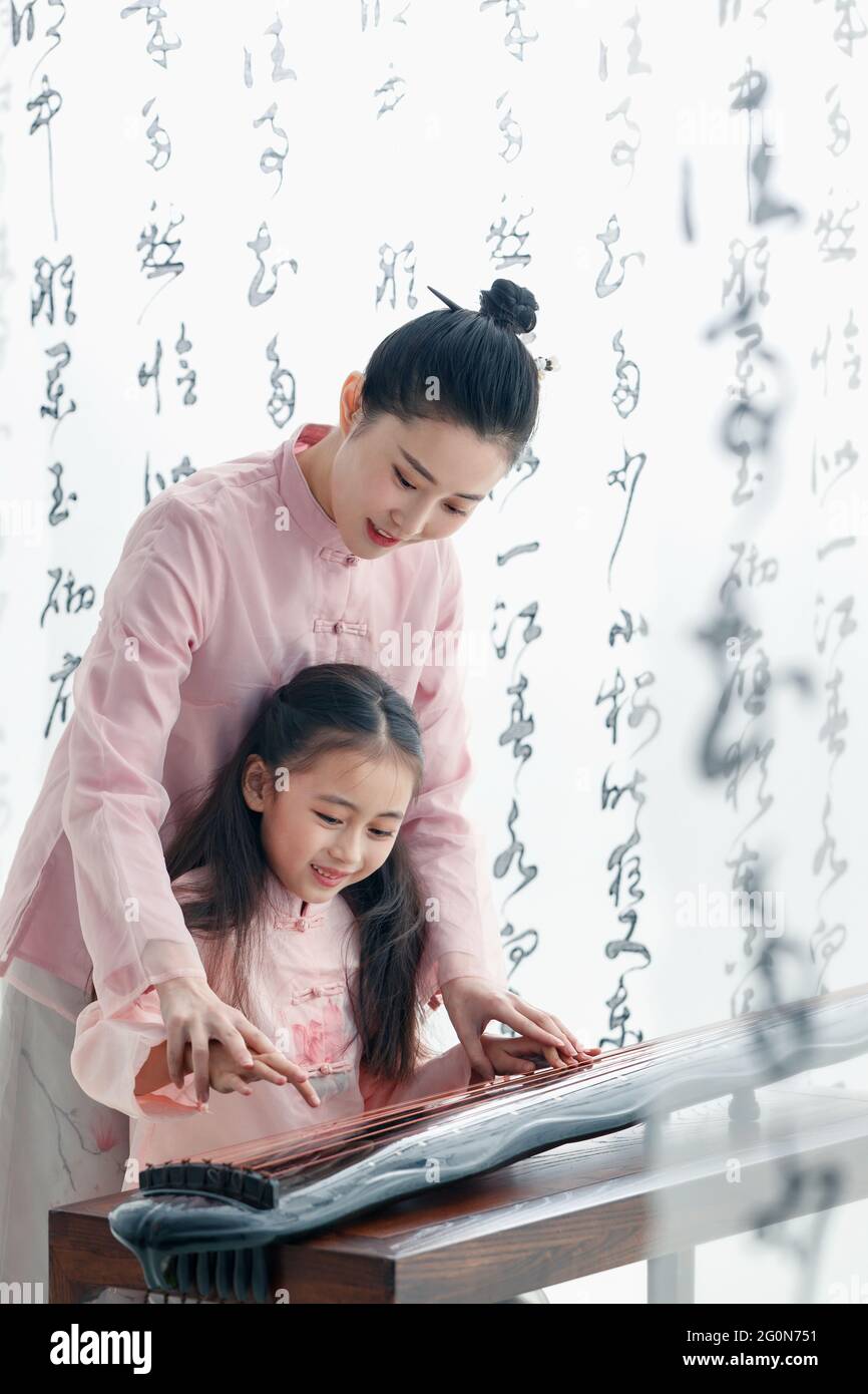 The youth teacher taught the pupils learn guzheng Stock Photo Alamy