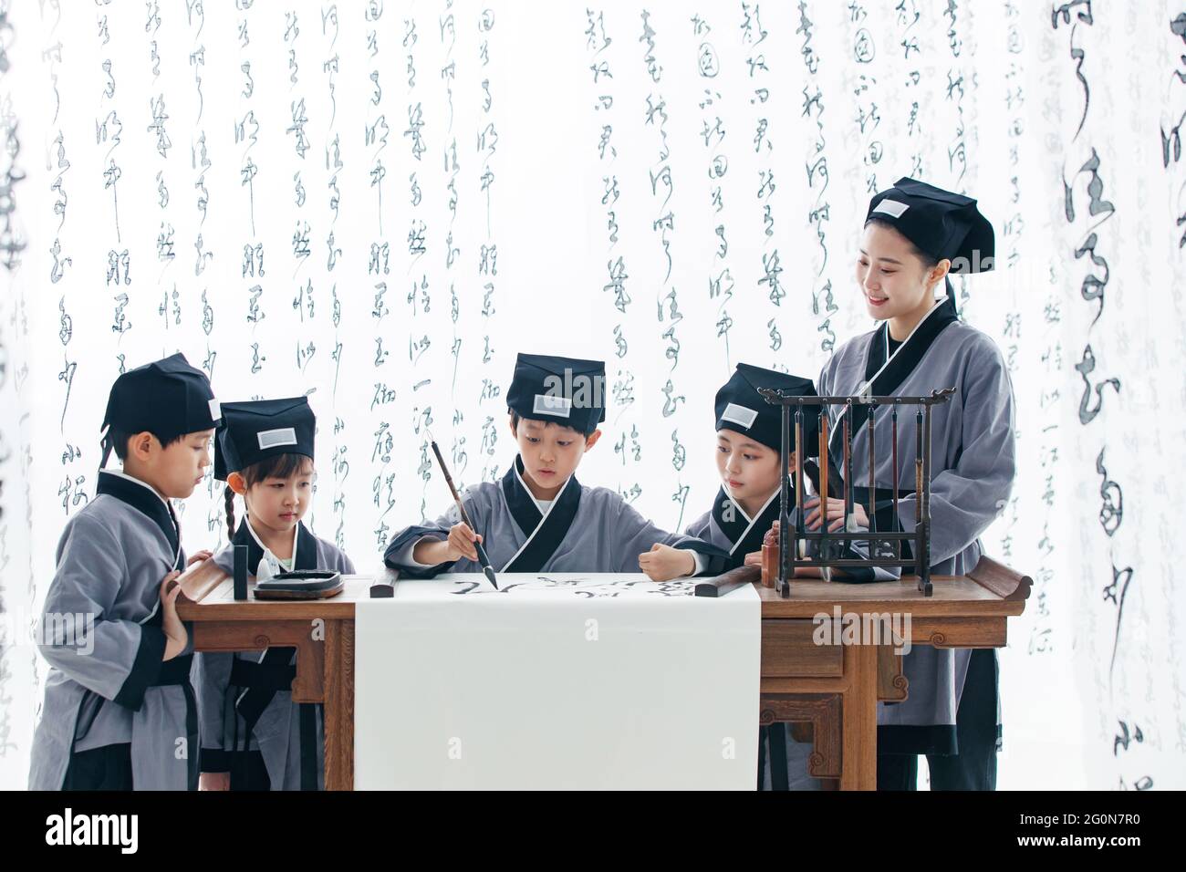 The teacher taught the pupils to learn calligraphy Stock Photo - Alamy