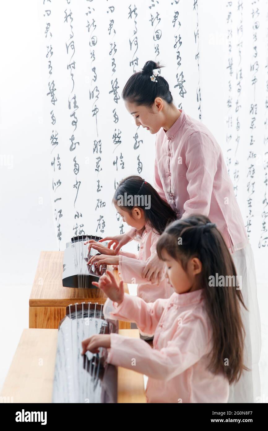 The youth teacher taught the pupils learn guzheng Stock Photo Alamy
