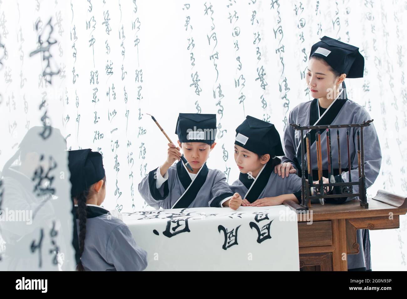 The teacher taught the pupils to learn calligraphy Stock Photo - Alamy
