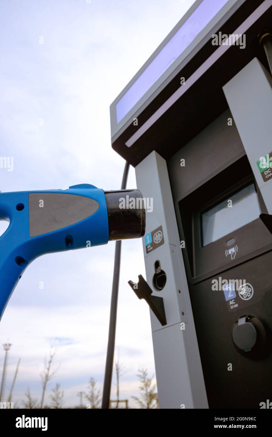 AC fast EV charger and EV charging station on the background. Electric