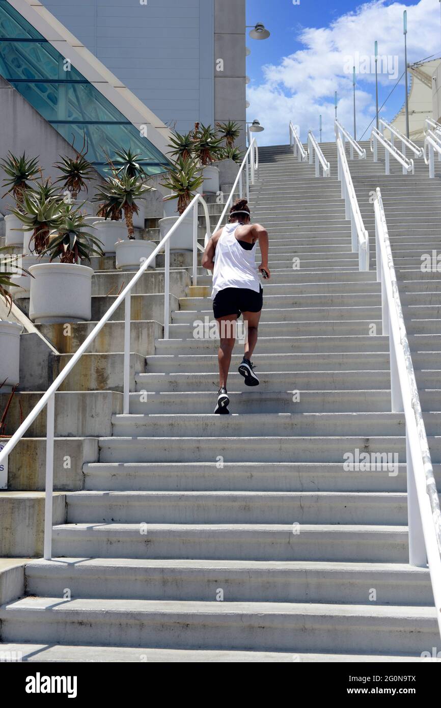 Adult male jogging up the SD Convention Center stairs in San Diego