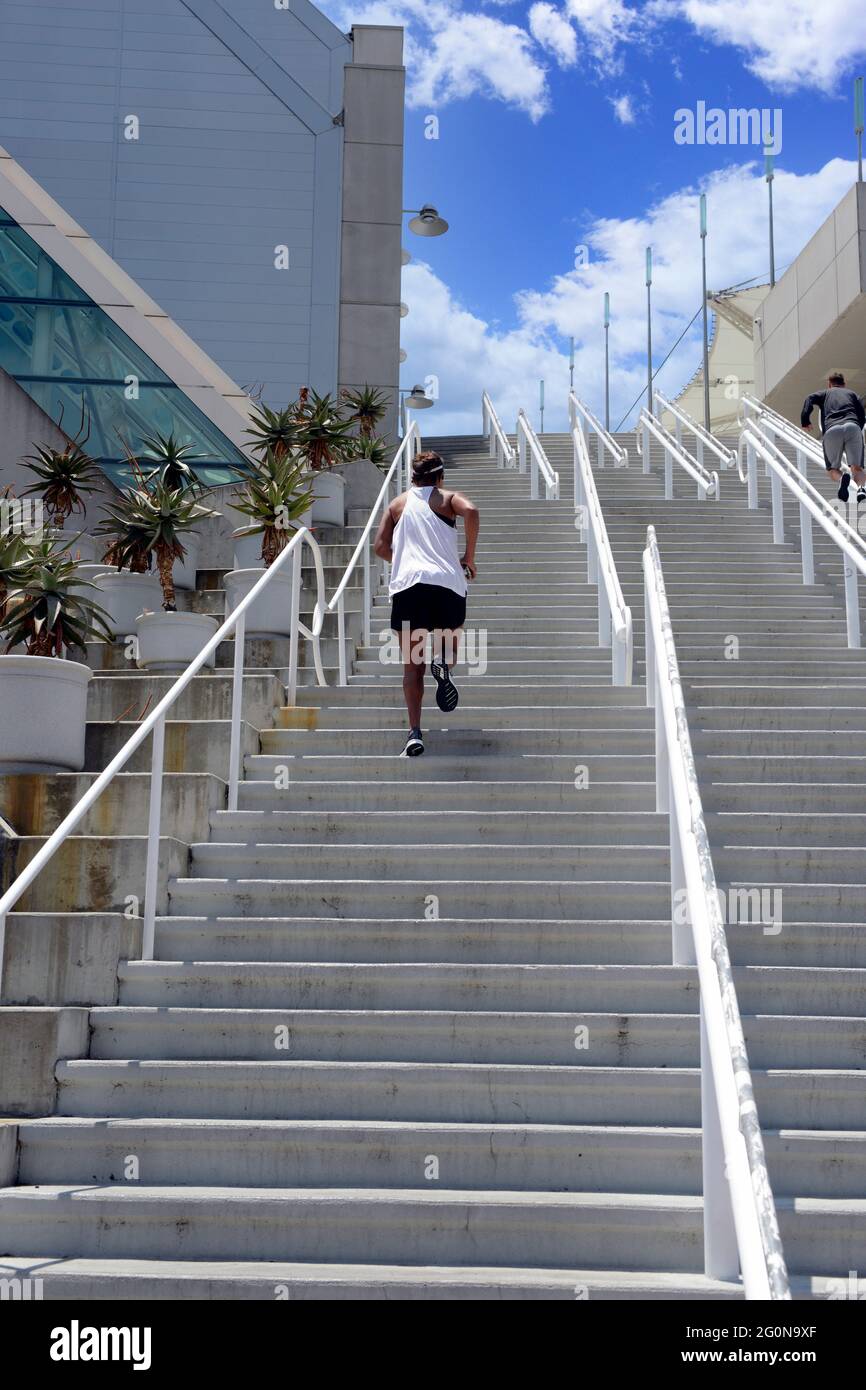 Adult male jogging up the SD Convention Center stairs in San Diego