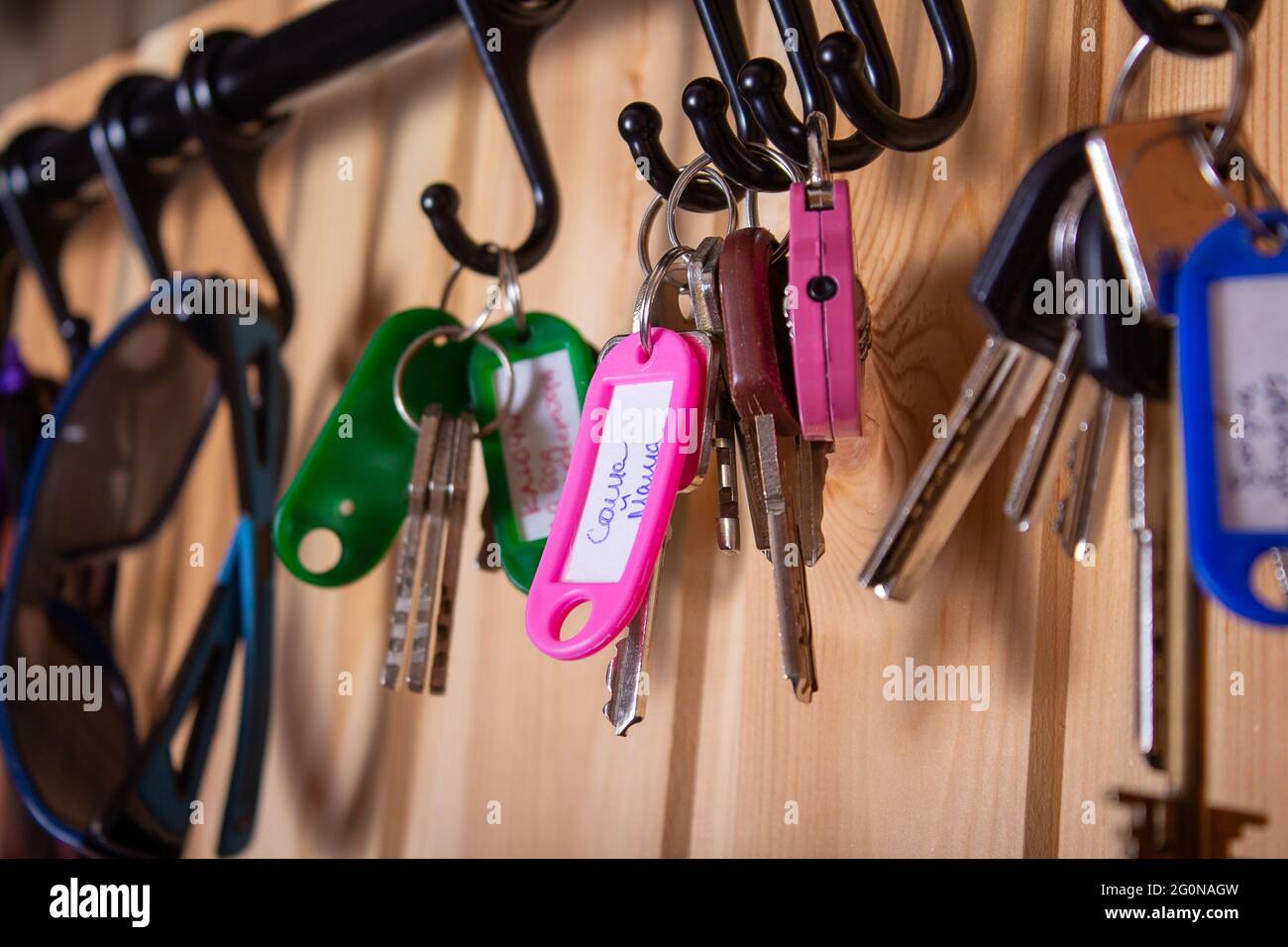 Key holder with keys hanging on the wall Stock Photo - Alamy