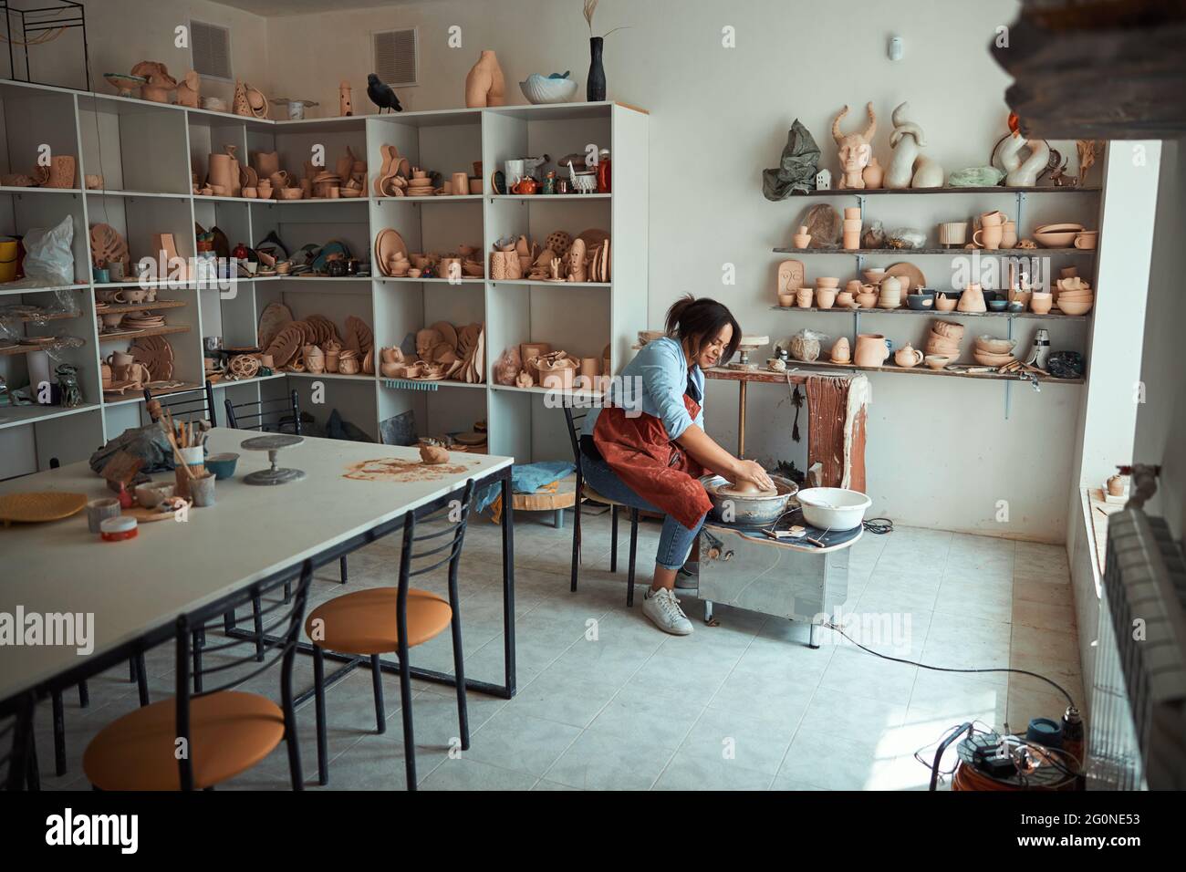 Nice female potter making pottery in workshop Stock Photo - Alamy