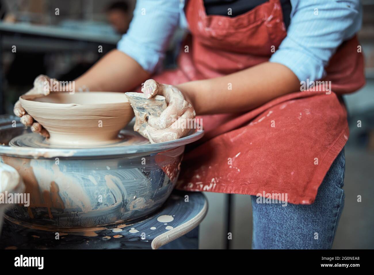 Female ceramist polishing clay bowl in Stock Photo Alamy