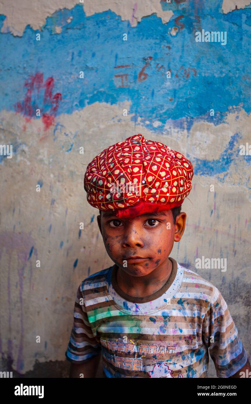 Portrait of an Indian boy with face smudged with Multiple colour Stock Photo