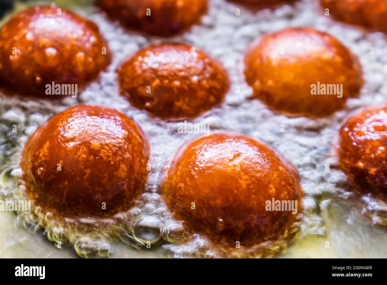 indian sweet Gulab jamun oil frying in a pan for the celebration of the festival. Stock Photo