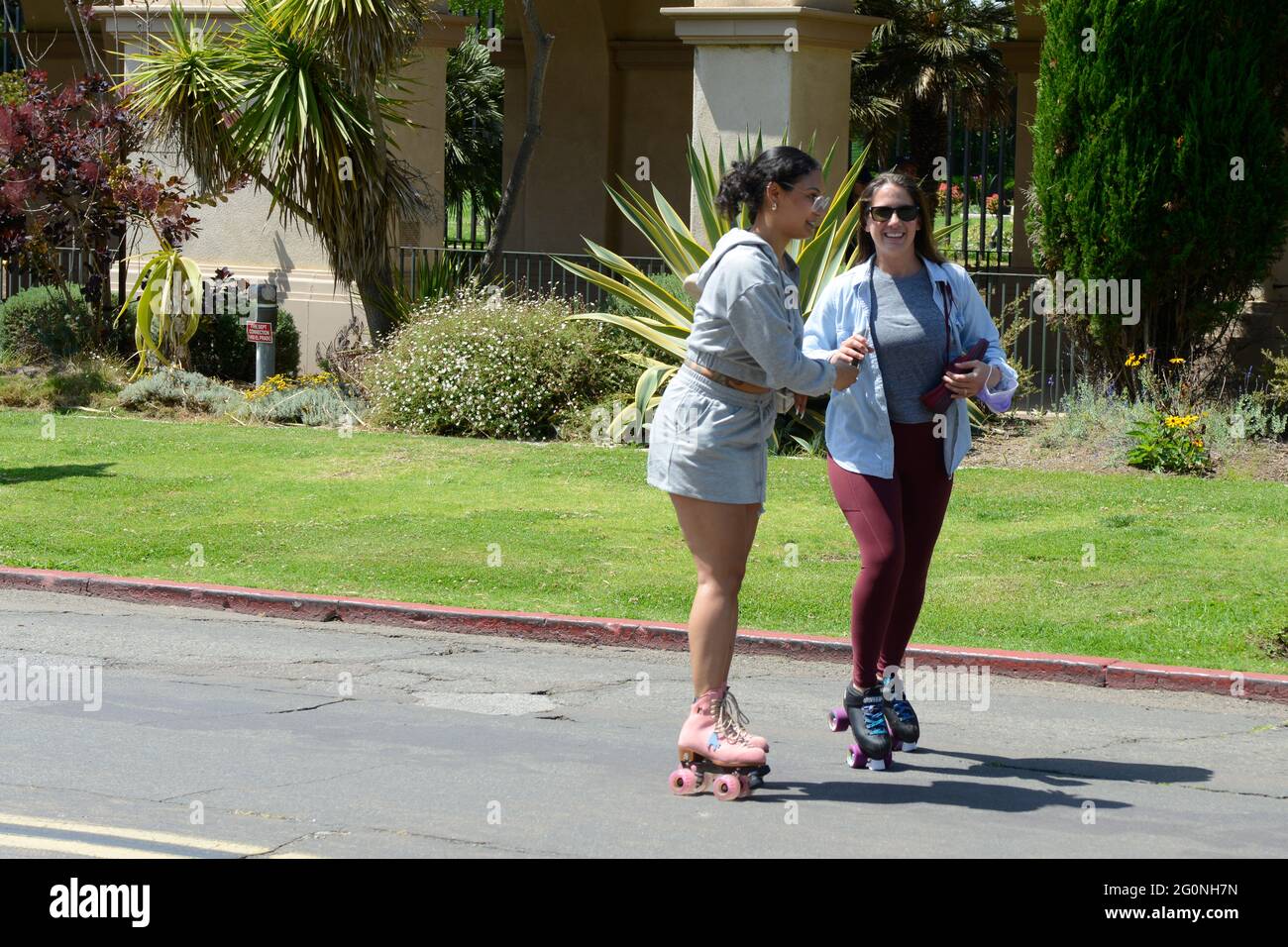 Two young women roller skating along El Prado in Balboa Park in San Diego, CA Stock Photo Alamy