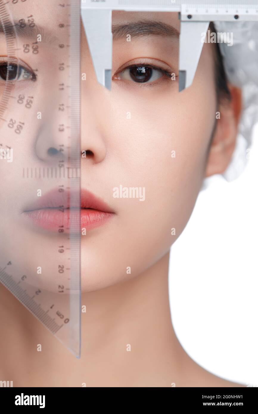 Young women face is measured with a caliper Stock Photo Alamy