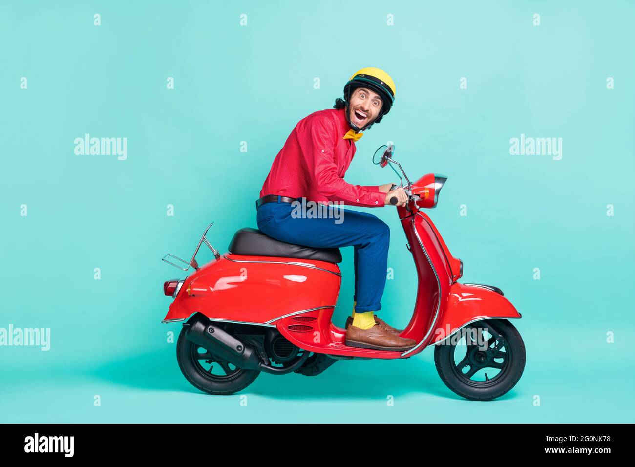 Full body profile side photo of funky amazed man ride motorbike isolated on pastel teal color background Stock Photo
