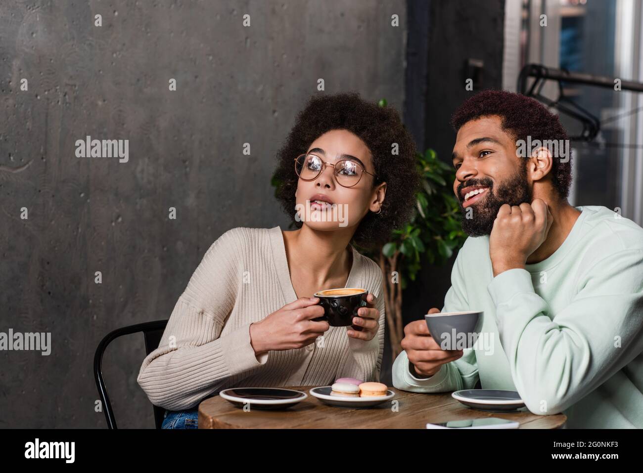 African american couple with coffee sitting in cafe Stock Photo - Alamy