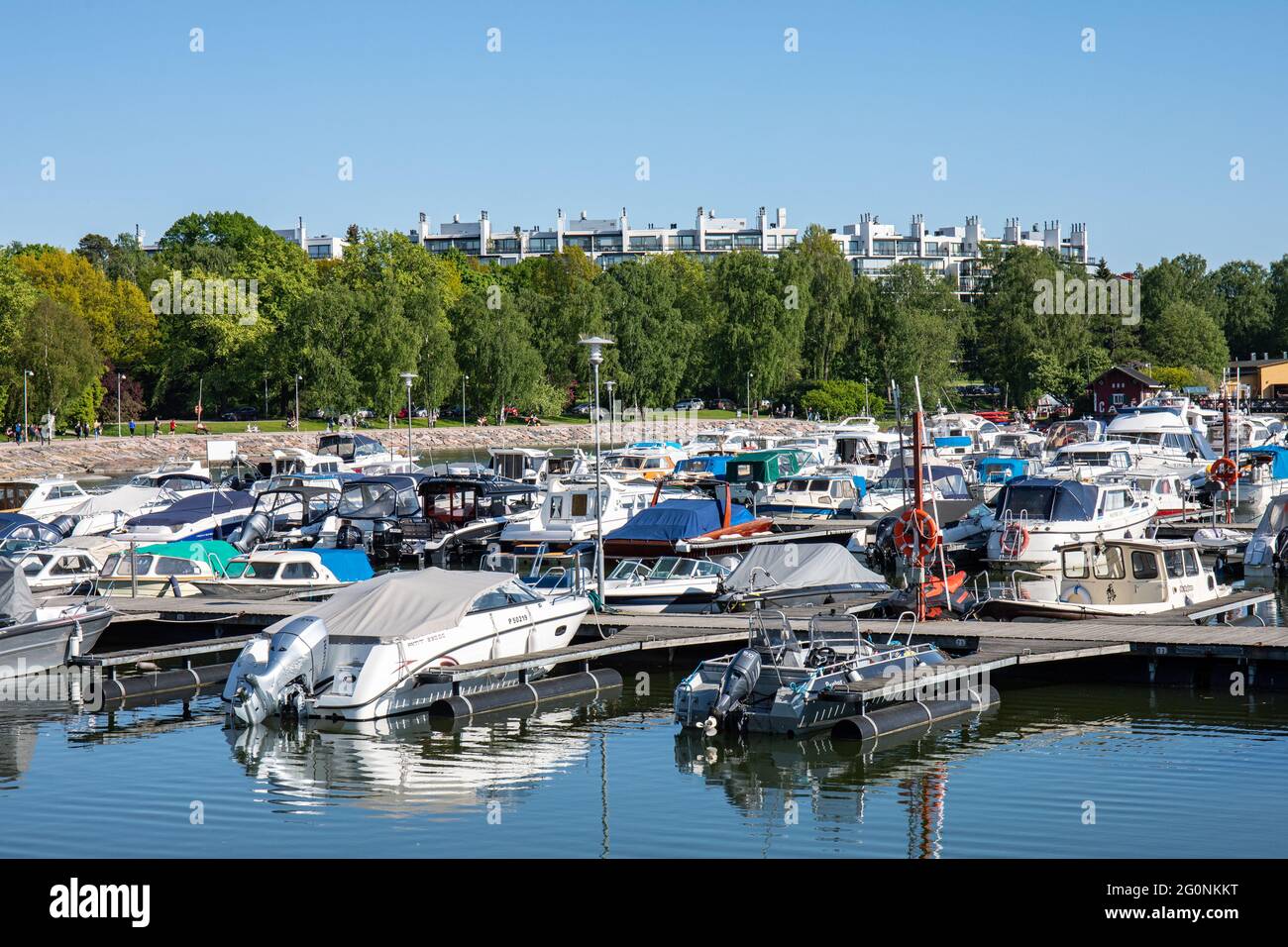 Humallahden venekerho jetties and motorboats. Kesäkatu residential buildings in the background. Taka-Töölö district of Helsinki, Finland. Stock Photo