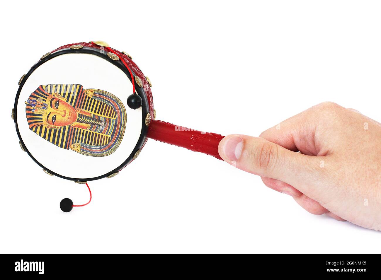 Drum in hand. Hand drum with bells on a white background. Drum with Egyptian drawings Stock Photo