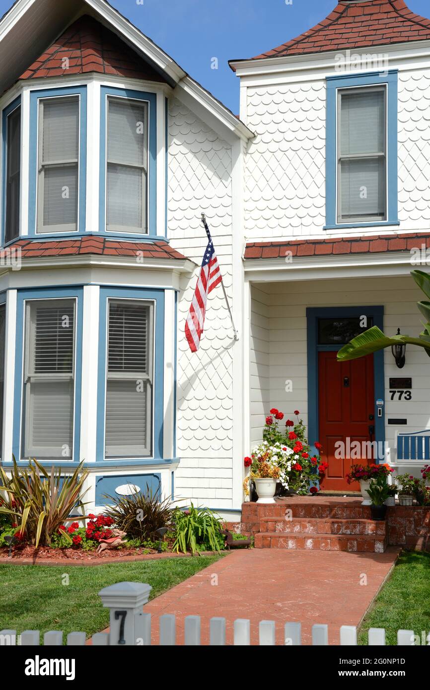 Mid-19th Century wood shingle home with an American flag on Orange Ave in Coronado City, San Diego, California Stock Photo