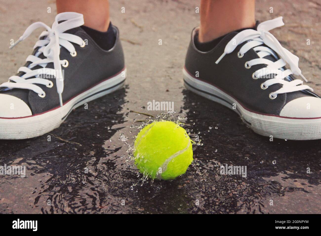 Tennis ball in the water. Tennis Ball and Water Drops Stock Photo