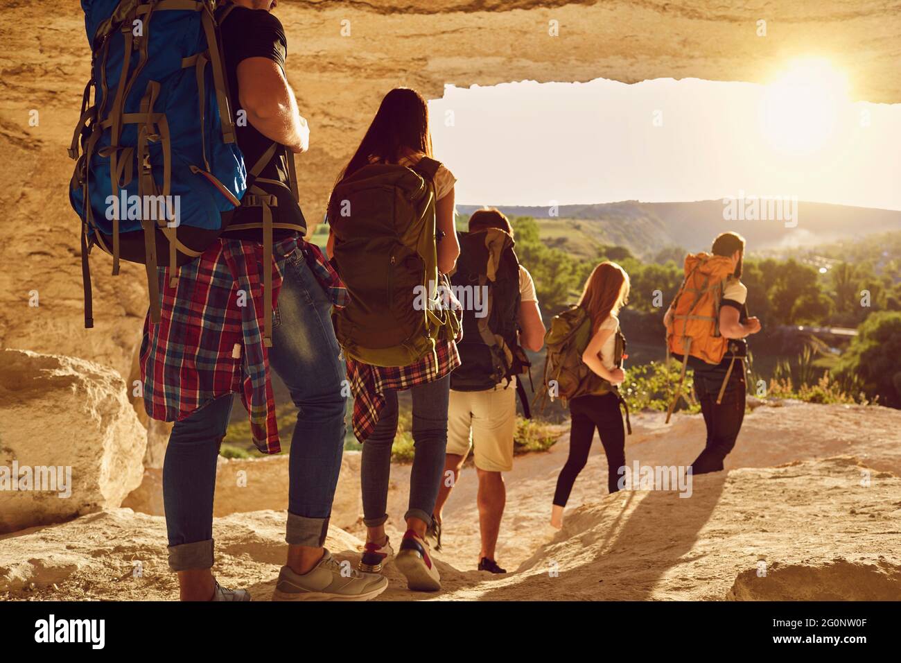 Group of travelers hikers hiking in natural mountaints outdoors with great landscape ahead Stock Photo