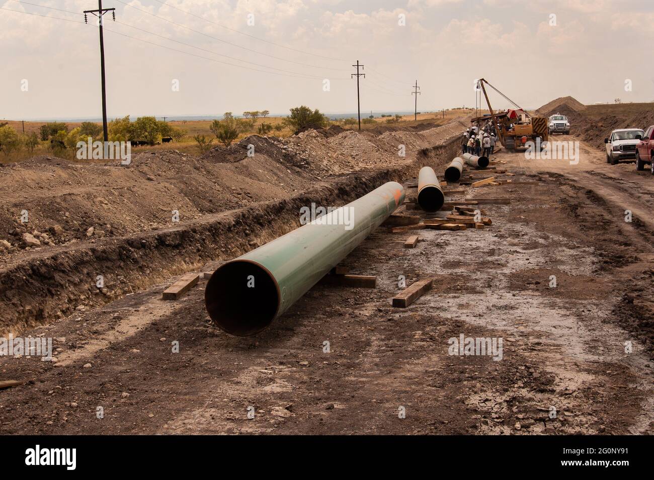 Natural gas pipeline built in north Texas getting natural gas to market. Pipes welded together and busied underground carry natural gas from wells to refineries. High-pressure fracturing opened up new and old oil fields in Texas and helped move the country away from using coal. Stock Photo