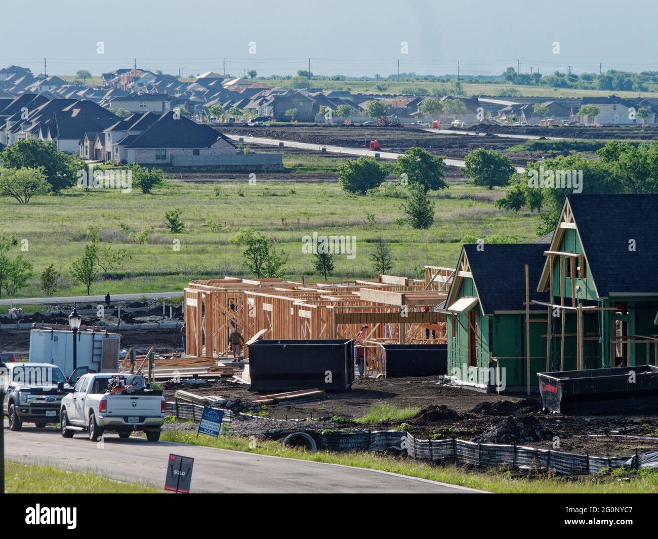 One of the fastest growing states in the USA, large new homes take over the prairie north of Fort Worth, Texas, midway between Fort Worth and Dallas and a direct highway into Dallas, Texas. Shortage of wood has caused prices for new homes to rise even more. Stock Photo