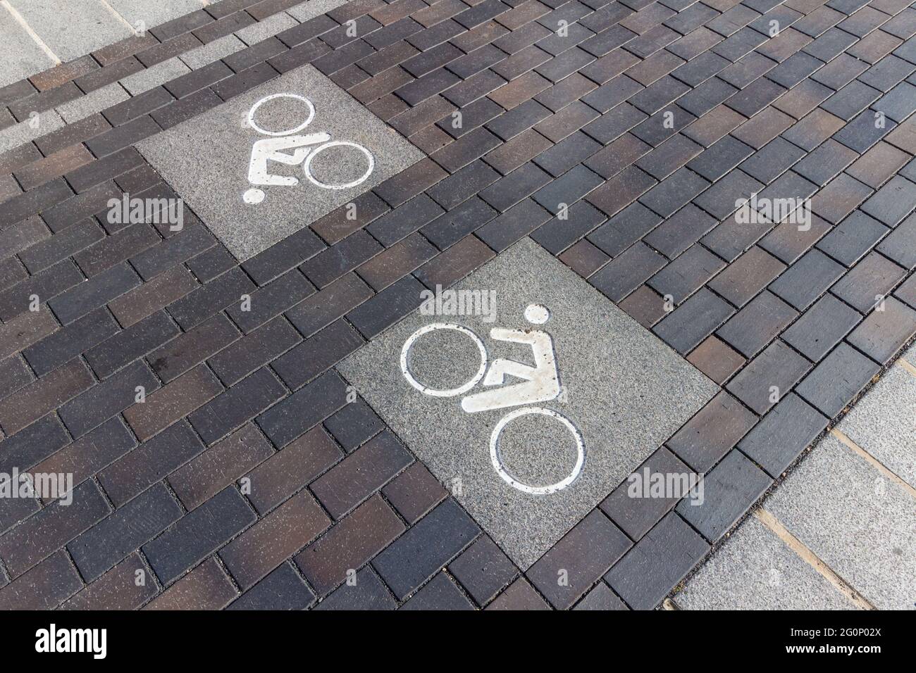 Stone sign of bike lane built into the road surface, Sopron, Hungary Stock Photo